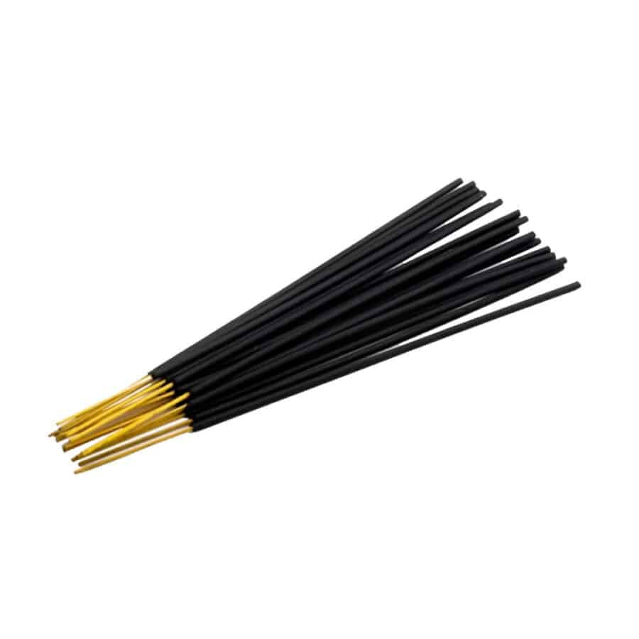 Black and gold incense sticks on a white background